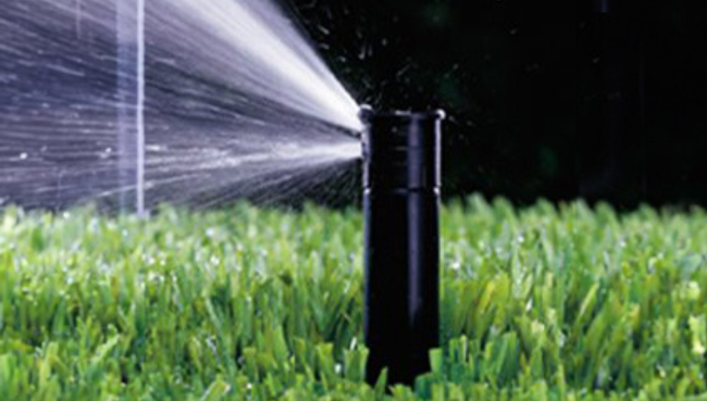 Close-up of a lawn sprinkler head in action